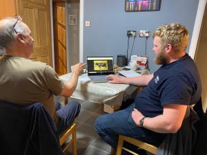 Jim Johnson and Gary Keith judging in the Online Show. North House Miriam on the computer.